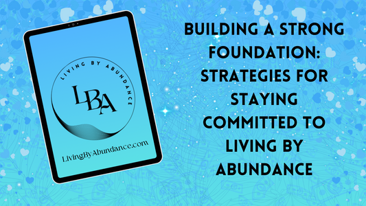 Digital graphic of a tablet displaying 'Building a Strong Foundation: Strategies for Staying Committed to Living By Abundance' on a blue, heart-decorated background.