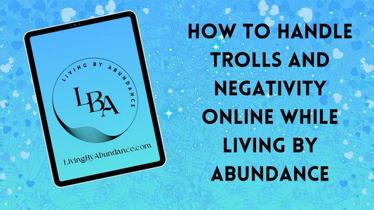 Digital graphic of a tablet displaying 'Living By Abundance' with the title 'How to Handle Trolls and Negativity Online While Living By Abundance' on a blue, heart-decorated background.