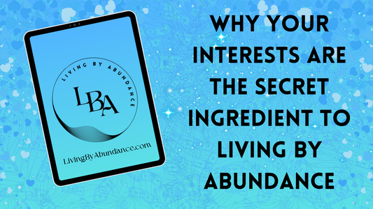 Digital graphic of a tablet displaying 'Why Your Interests Are the Secret Ingredient to Living By Abundance' on a blue, heart-decorated background.